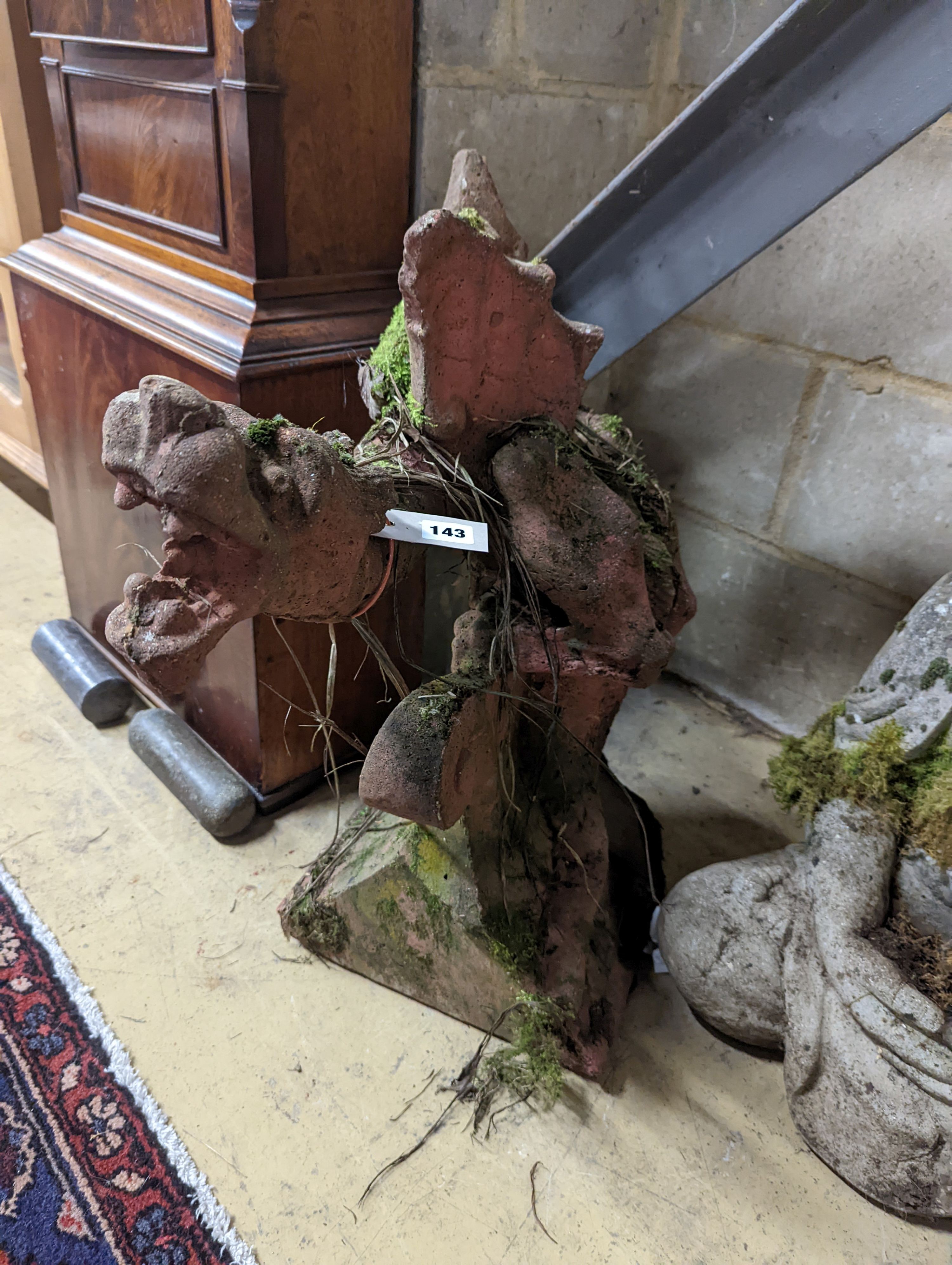 A weathered terracotta dragon hip tile, height 64cm
